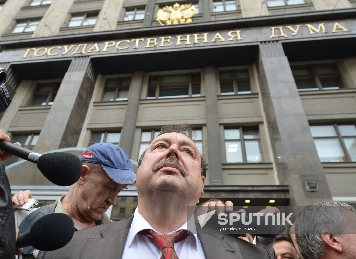 Gennady Gudkov speaking to reporters outside the State Duma