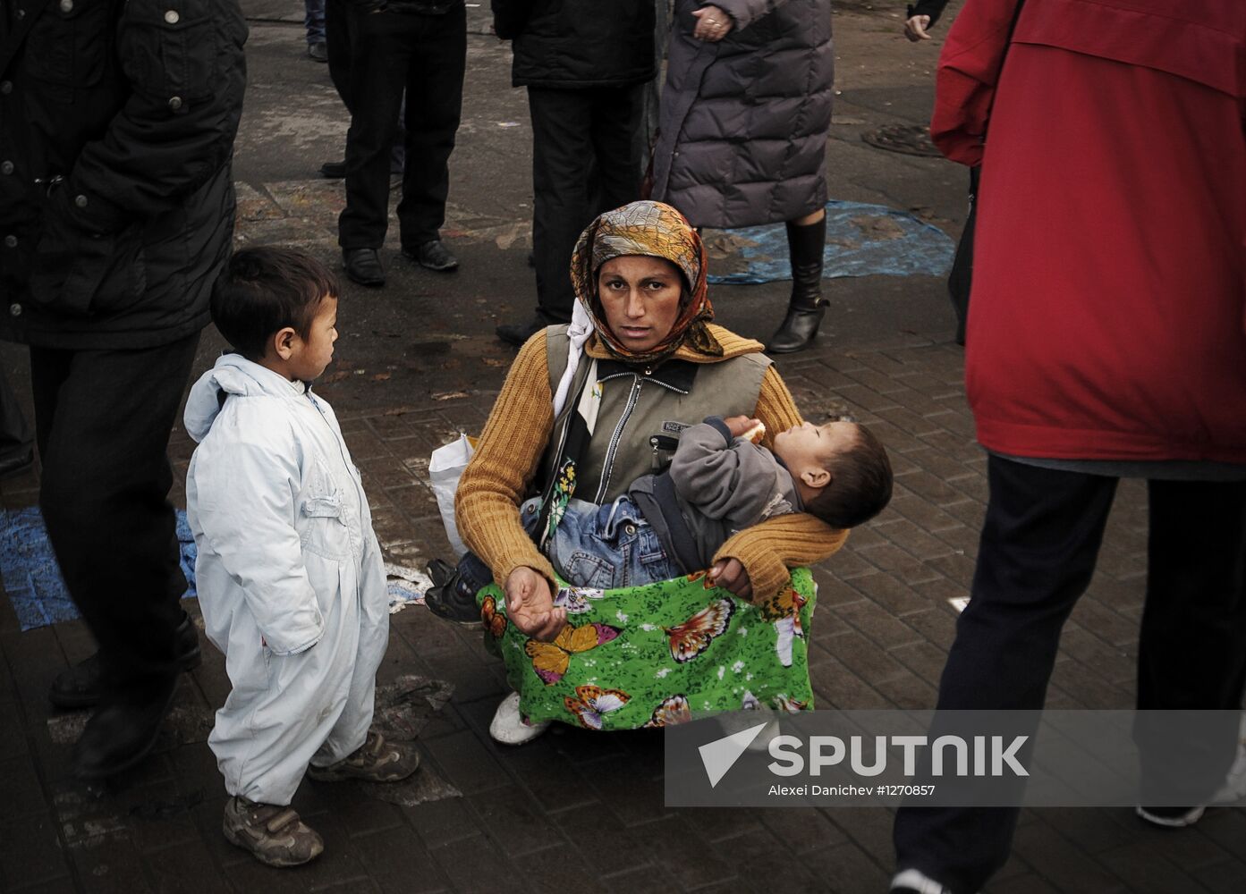 Gypsy woman with children on street of St. Petersburg