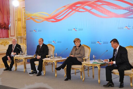 Vladimir Putin and Angela Merkel at St. Petersburg Dialog Forum