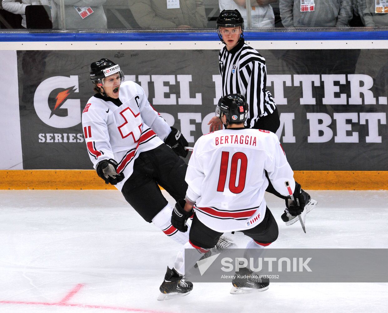 Swiss players Christoph Bertschy (left) and Alessio Bertaggia rejoice after scoring a goal in the quarterfinal match of the youth World Hockey Championship between the national teams of Russia and Switzerland. Location: Russia, Republic of Bashkortostan, Ufa. Author: Alexey Kudenko/Sputnik. Hockey Youth World Championship. Quarterfinal Russia-Switzerland