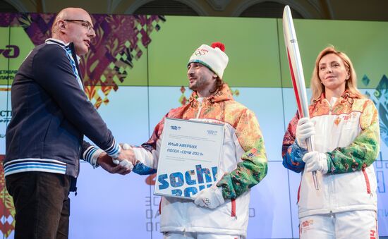 Olympic Flame Relay torch and uniform presented
