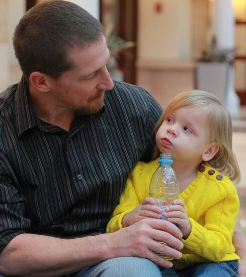 American family receive documents for adoption