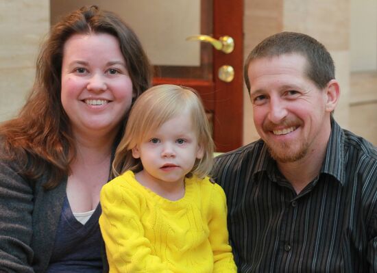 American family receive documents for adoption