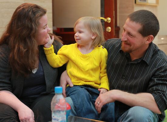 American family receive documents for adoption