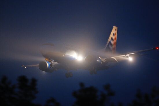 An airplane landing in the fog