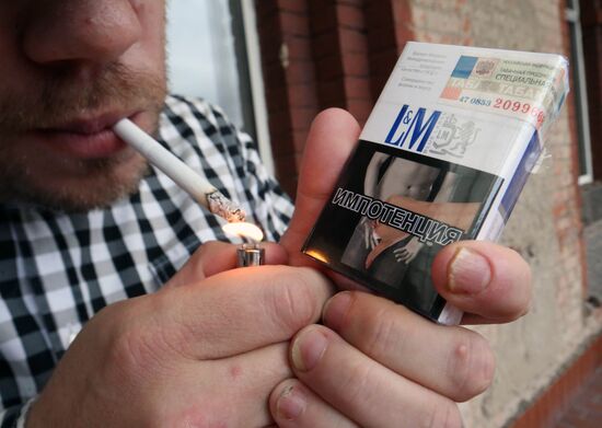 Cigarette packs with pictures warning of smoking consequences