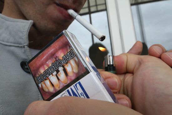 Cigarette packs with pictures warning of smoking consequences
