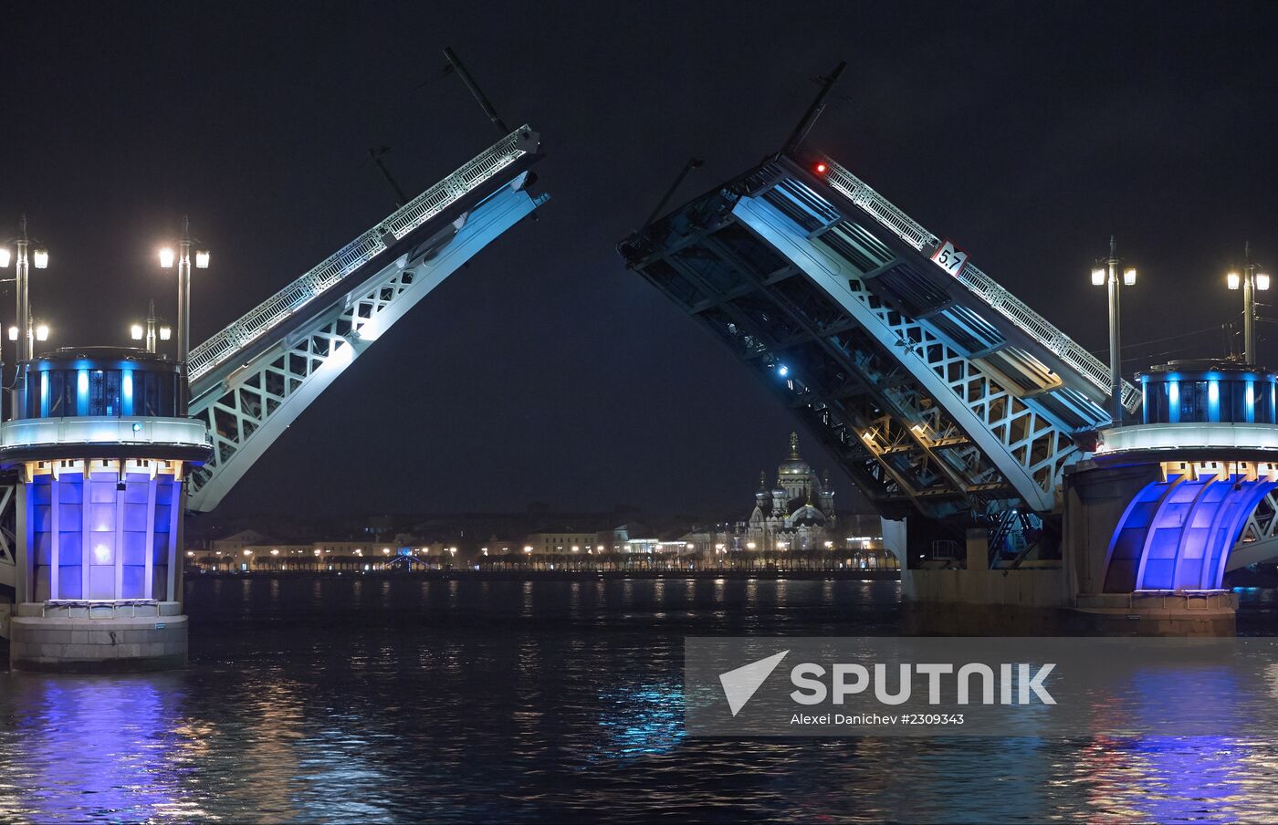 Vessels sail under raised Blagoveshchensky Bridge in St. Petersburg