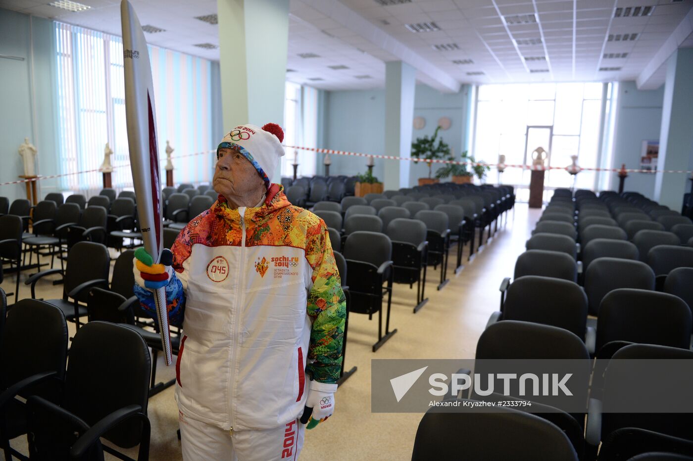 Siberian centenarian Alexander Kaptarenko carries the Olympic flame