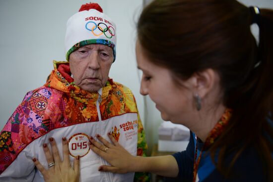 Siberian centenarian Alexander Kaptarenko carries the Olympic flame