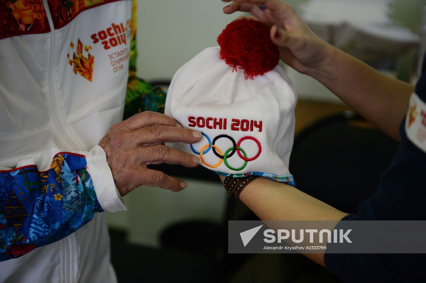 Siberian centenarian Alexander Kaptarenko carries the Olympic flame
