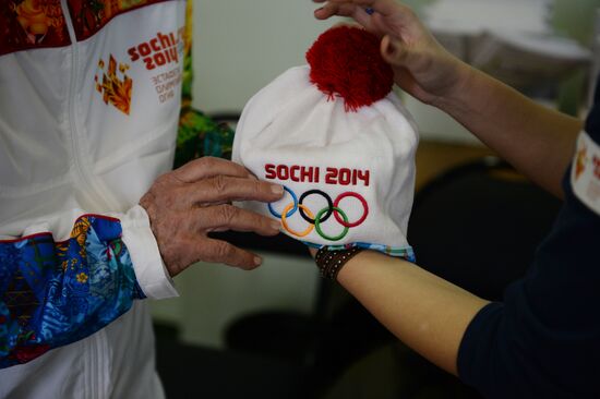 Siberian centenarian Alexander Kaptarenko carries the Olympic flame