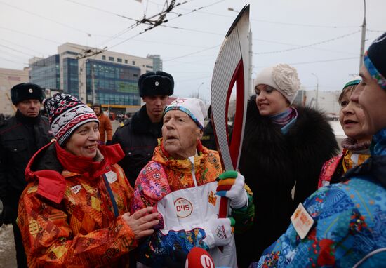 Siberian centenarian Alexander Kaptarenko carries the Olympic flame