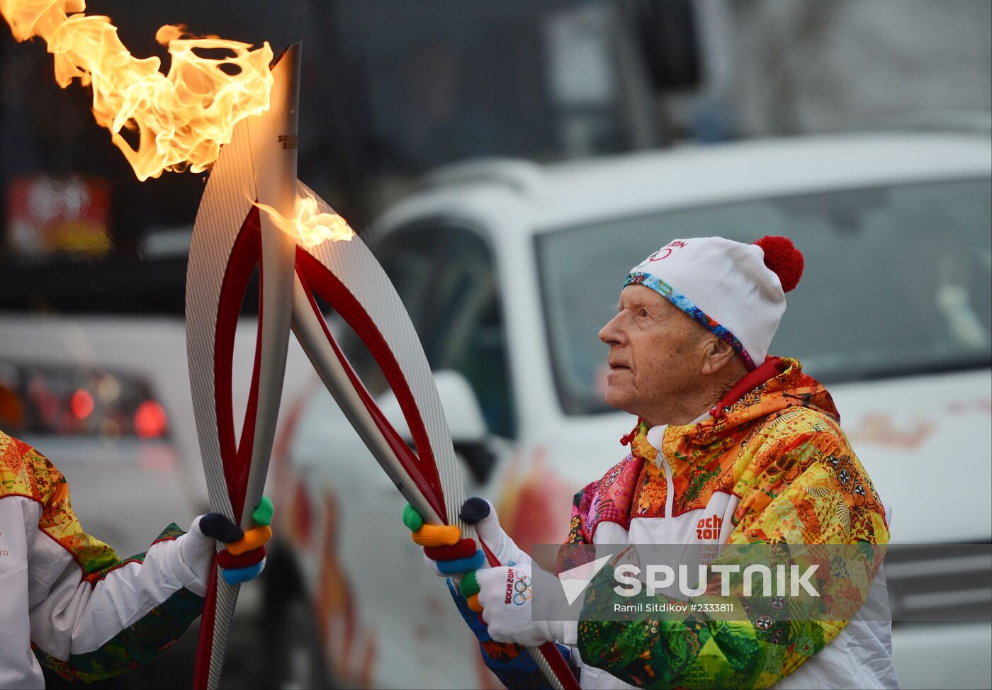 Siberian centenarian Alexander Kaptarenko carries the Olympic flame