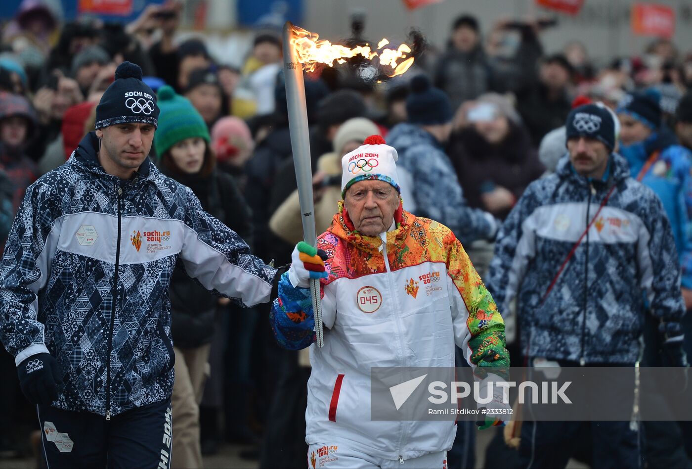 Siberian centenarian Alexander Kaptarenko carries the Olympic flame