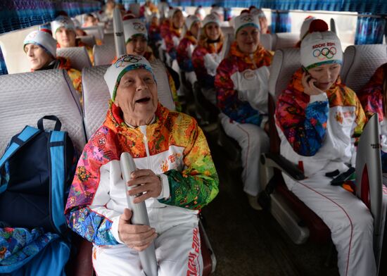 Siberian centenarian Alexander Kaptarenko carries the Olympic flame