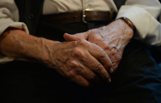 Siberian centenarian Alexander Kaptarenko carries the Olympic flame