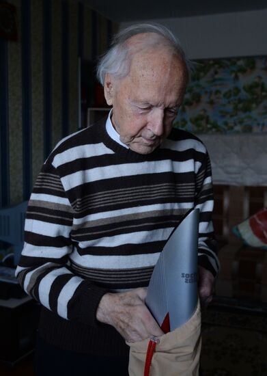 Centenarian Alexander Kaptarenko carries the Olympic flame