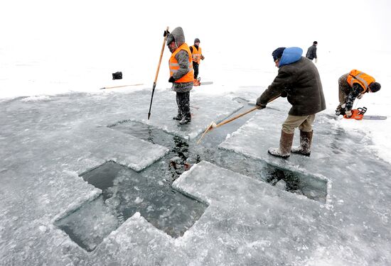 Preparation of ice holes for Epiphany bathing in Russia