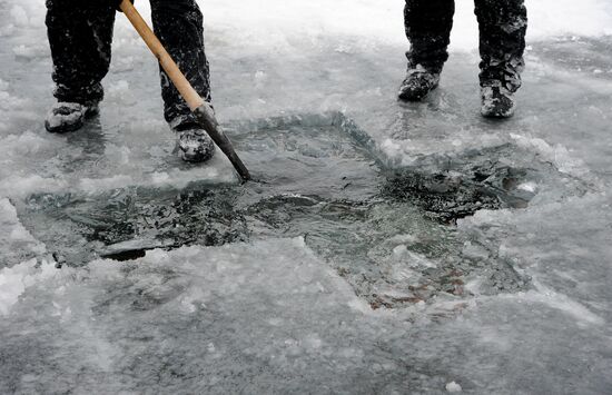 Preparation of ice holes for Epiphany bathing in Russia