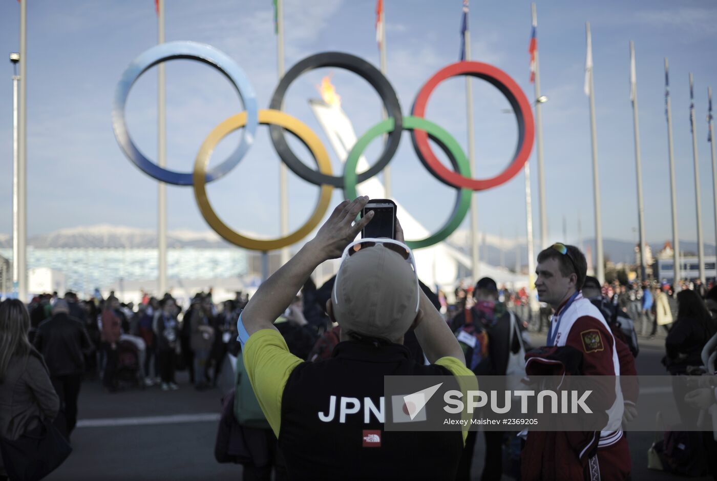 Japanese sports fans pose for pictures with the Olympic rings. Location: Russia, Krasnodar region, Sochi. Author: Alexey Maishev/Sputnik. 2014 Winter Olympics. Life of Olympic Park
