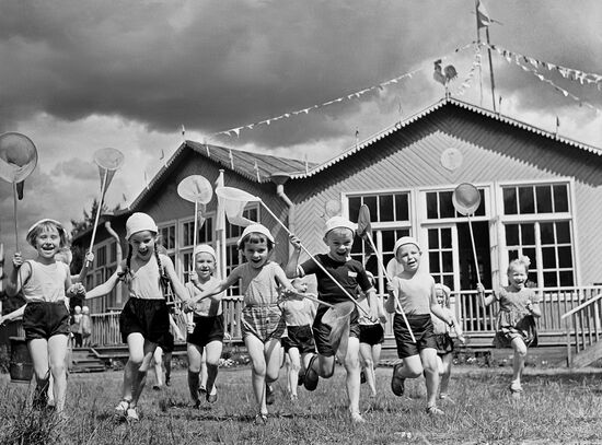 Children from a daycare center near their dacha in summer