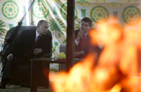 Vladimir Putin and Muammar Qaddafi