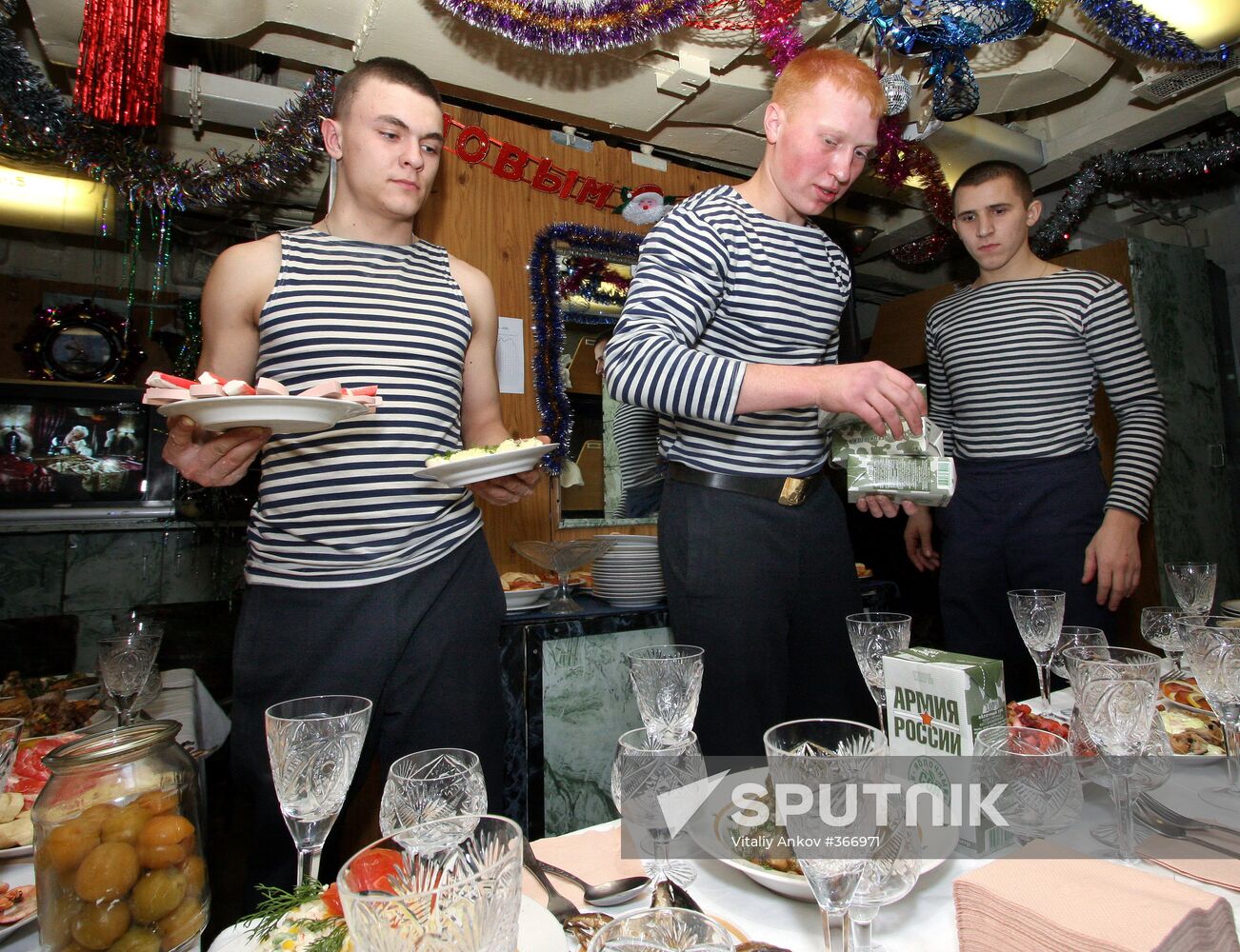 Sailors setting the table for the New Year's party aboard the anti-submarine ship Admiral Panteleyev of the Pacific Fleet. Location: Russia, Vladivostok. Author: Vitaliy Ankov/Sputnik. Seeing in New Year aboard Admiral Panteleyev