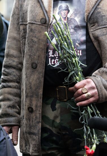Waffen SS legionnaires and their supporters marching in Riga