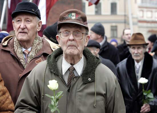 Waffen SS legionnaires and their supporters marching in Riga