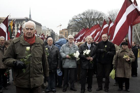 Waffen SS legionnaires and their supporters marching in Riga