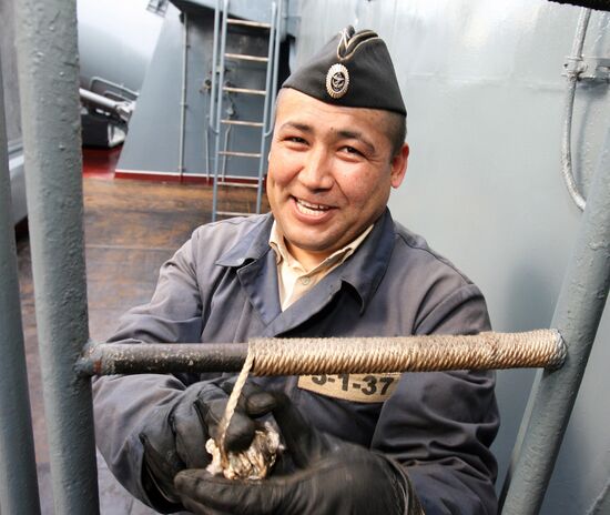 Sailors cleaning up Varyag missile cruiser