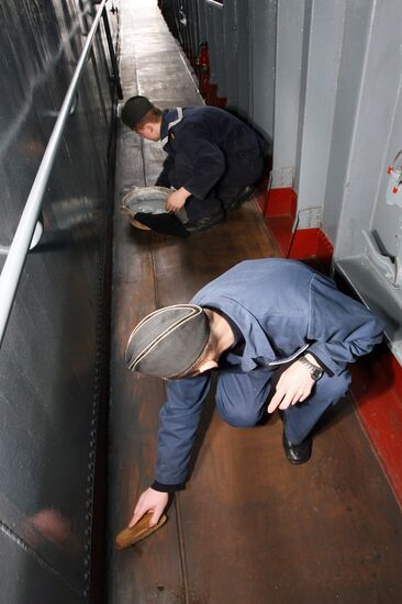Sailors cleaning up Varyag missile cruiser
