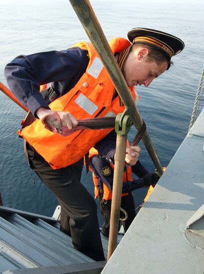 Sailors cleaning up Varyag missile cruiser