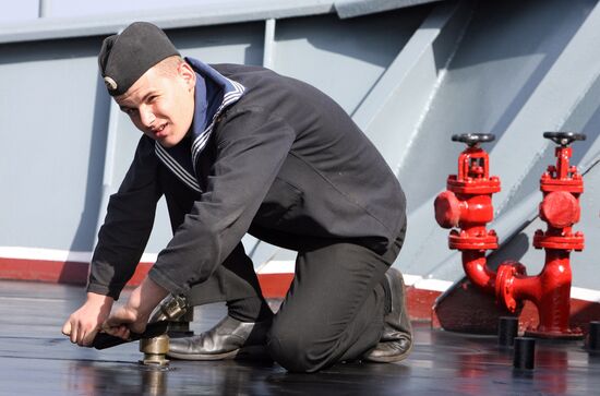 Sailors cleaning up Varyag missile cruiser