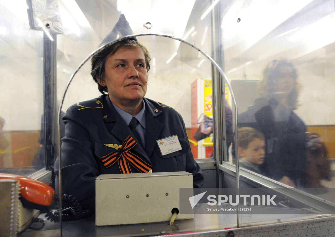 Metro workers adorning their uniforms with St. George ribbons