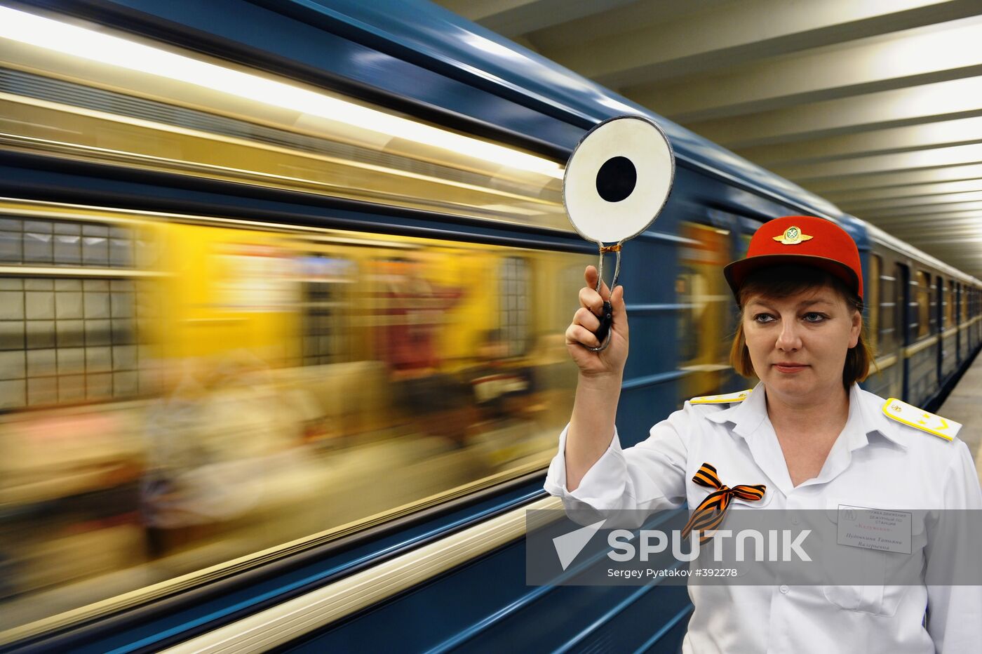 Metro workers adorning their uniforms with St. George ribbons