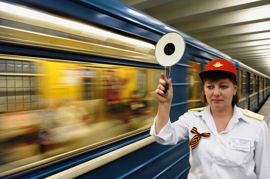 Metro workers adorning their uniforms with St. George ribbons