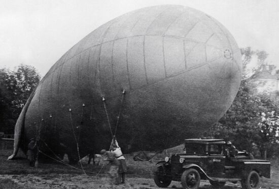Servicemen installing a barrage balloon