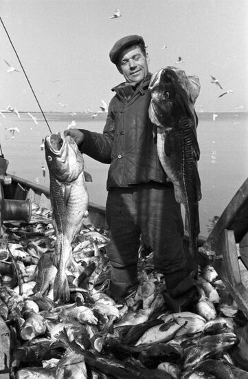 Member of Latvian artel, Jacob Burke, after good fishing