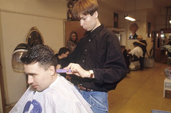 Hair stylist Sergei Zverev making Bogdan Titomir's hairdo