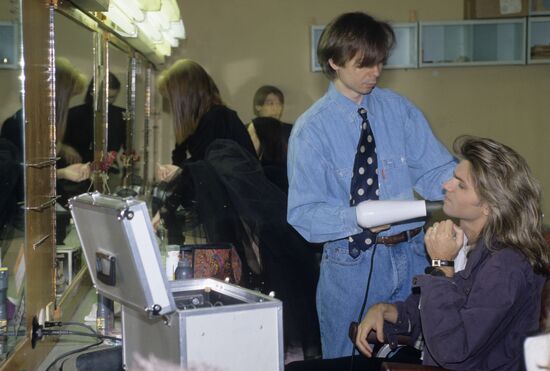 Hair stylist Sergei Zverev working on Dmitry Malikov's hairdo