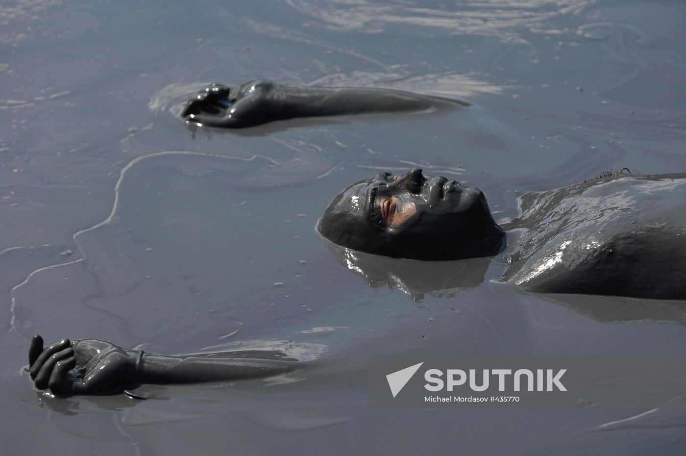 Mud bath in crater of Tizdar Volcano in Sea of Azov