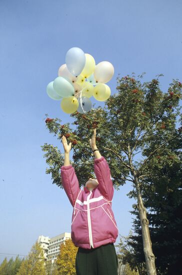 Child letting go of balloons