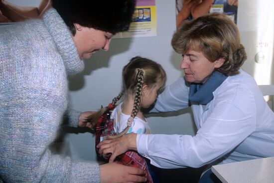Doctor examines child