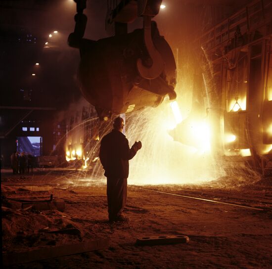 Pouring cast iron into furnace
