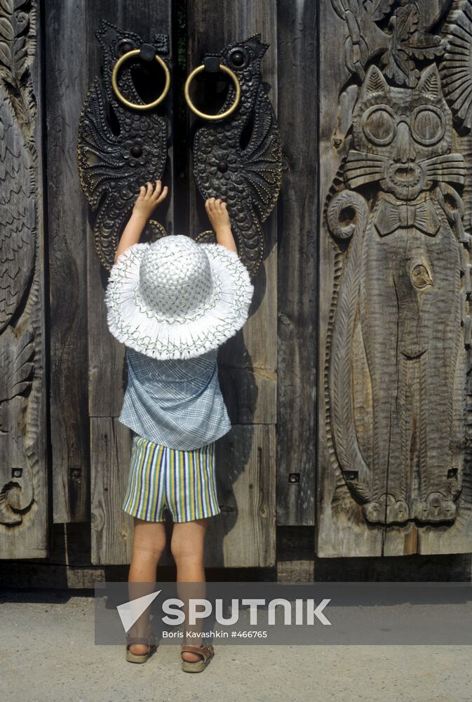Child opening door to Fairy Tale Lawn