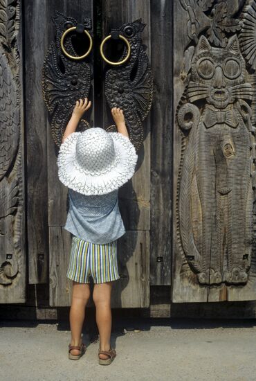 Child opening door to Fairy Tale Lawn