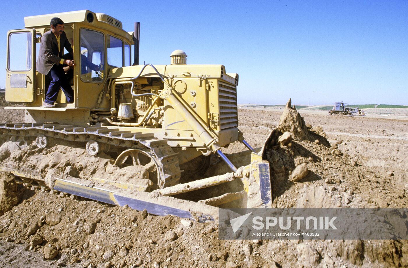 Ploughing desert land.