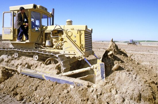 Ploughing desert land.